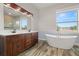 Elegant bathroom with double vanity, large soaking tub, and window at 6016 82Nd N Ter, Pinellas Park, FL 33781