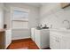 Laundry room with white cabinets, shelving, and a utility sink at 6016 82Nd N Ter, Pinellas Park, FL 33781