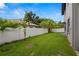 Spacious backyard with grassy lawn and white vinyl fence at 6016 82Nd N Ter, Pinellas Park, FL 33781