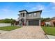 Beautiful two-story house with a red door, gray siding and a paved driveway at 6016 82Nd N Ter, Pinellas Park, FL 33781
