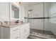 Updated bathroom with white cabinets, granite countertop, and a large glass shower at 6016 82Nd N Ter, Pinellas Park, FL 33781