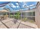 Screened patio with brick pavers and lush landscaping at 3864 Darston St, Palm Harbor, FL 34685