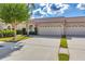 Exterior view of two-unit condo building with attached garages and landscaping at 3864 Darston St, Palm Harbor, FL 34685