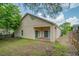 House exterior, backyard with patio and wooden fence at 1950 Lillian Ave, Tarpon Springs, FL 34689
