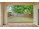 Brick patio with sliding glass doors and view of backyard at 1950 Lillian Ave, Tarpon Springs, FL 34689