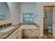 Updated bathroom with granite vanity, tile flooring, and a large soaking tub at 1950 Lillian Ave, Tarpon Springs, FL 34689