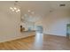 Open living room with high ceilings and hardwood floors, featuring a kitchen with granite countertops at 1950 Lillian Ave, Tarpon Springs, FL 34689