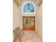 Inviting entryway with double doors and arched window at 1950 Lillian Ave, Tarpon Springs, FL 34689