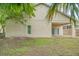 Back of house showing patio and fenced backyard at 1950 Lillian Ave, Tarpon Springs, FL 34689