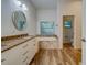 Spa-like bathroom with double vanity, granite countertop, and soaking tub at 1950 Lillian Ave, Tarpon Springs, FL 34689