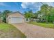 Newly built home with a white garage door and paver driveway at 1950 Lillian Ave, Tarpon Springs, FL 34689