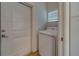 Bright laundry room with washer, dryer, and built-in shelving at 1950 Lillian Ave, Tarpon Springs, FL 34689