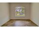 Bright bedroom with wood-look tile flooring and a large window at 1950 Lillian Ave, Tarpon Springs, FL 34689