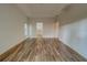 Large bedroom with wood-look floors and access to the bathroom at 1950 Lillian Ave, Tarpon Springs, FL 34689