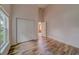 Spacious bedroom with wood-look floors, window, and closet at 1950 Lillian Ave, Tarpon Springs, FL 34689
