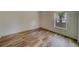 Well-lit bedroom with wood-look floors and a window offering a view at 1950 Lillian Ave, Tarpon Springs, FL 34689