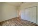 Spacious bedroom featuring wood-look floors and ample closet space at 1950 Lillian Ave, Tarpon Springs, FL 34689