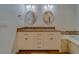 Bathroom with double vanity, granite countertops and oval mirrors at 1950 Lillian Ave, Tarpon Springs, FL 34689