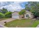 Two-story home with a white garage door and brick driveway at 1950 Lillian Ave, Tarpon Springs, FL 34689