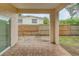 Covered patio with view of fenced backyard at 1950 Lillian Ave, Tarpon Springs, FL 34689