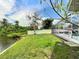 Landscaped backyard with lake access and pool view at 6460 Fairway View S Blvd, St Petersburg, FL 33707