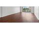 Bright, spacious room featuring hardwood floors and sliding glass doors to a balcony at 1200 N Shore Ne Dr # 301, St Petersburg, FL 33701