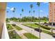 View of palm trees lining street and adjacent landscaped lawns seen from condo balcony at 1200 N Shore Ne Dr # 301, St Petersburg, FL 33701