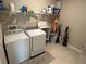 Well-equipped laundry room with washer, dryer, and shelving at 14005 Wineberry Dr, Dade City, FL 33525