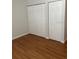 Bedroom with double door closet and wood flooring at 10196 Sailwinds S Blvd # 103, Largo, FL 33773