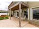 Covered patio with brick pavers, hot tub, and access to the pool at 22607 Southshore Dr, Land O Lakes, FL 34639