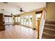 Bright Gathering room featuring tile floors, sliding doors to pool, and a staircase at 22607 Southshore Dr, Land O Lakes, FL 34639