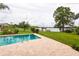 Inviting pool area with lake view, spacious patio and lush landscaping at 22607 Southshore Dr, Land O Lakes, FL 34639