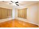Bedroom with hardwood floors and neutral-toned curtains at 22607 Southshore Dr, Land O Lakes, FL 34639