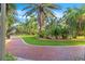 Brick pathway winds through lush tropical landscaping at 1200 N Shore Ne Dr # 301, St Petersburg, FL 33701