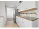 Modern kitchen with white cabinets, granite counters, and stainless steel appliances at 1200 N Shore Ne Dr # 301, St Petersburg, FL 33701