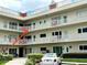 This condominium building features multiple floors and balconies with decorative red brick at 2263 Americus E Blvd # 53, Clearwater, FL 33763