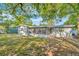 House back view with screened porch and large backyard at 10617 N 27Th St, Tampa, FL 33612