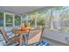 Screened porch with outdoor dining set and blue rug at 10617 N 27Th St, Tampa, FL 33612