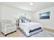 Bright bedroom with a queen-size bed and a comfortable armchair at 10617 N 27Th St, Tampa, FL 33612