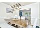 Bright dining room with farmhouse table and bench, offering view of the living room at 10617 N 27Th St, Tampa, FL 33612