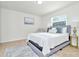 Spacious bedroom with a queen bed, tiled floors, and large window at 10617 N 27Th St, Tampa, FL 33612