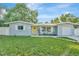 Cute ranch home with a yellow door and nicely landscaped yard at 10617 N 27Th St, Tampa, FL 33612