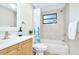 Bathroom with tub, shower, and light wood vanity at 10617 N 27Th St, Tampa, FL 33612