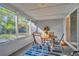 Screened porch with outdoor dining area and view of backyard at 10617 N 27Th St, Tampa, FL 33612