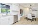 Eat-in kitchen with white cabinets, stainless steel appliances, and access to backyard at 10617 N 27Th St, Tampa, FL 33612