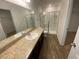 Bathroom with a shower, toilet and vanity with a mirror at 35182 White Water Lily Way, Zephyrhills, FL 33541