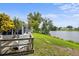 Outdoor wooden deck overlooking the backyard and serene lake at 4035 Glissade Dr, New Port Richey, FL 34652