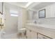 Bright bathroom featuring a walk-in shower, gold accents, and a large mirror at 4035 Glissade Dr, New Port Richey, FL 34652