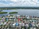 Waterfront home featuring a spacious lot, lush landscaping, and close proximity to the beach at 704 180Th E Ave, Redington Shores, FL 33708