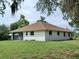 White single story house with brown roof and large grassy yard at 1318 Manasota Beach Rd, Englewood, FL 34223